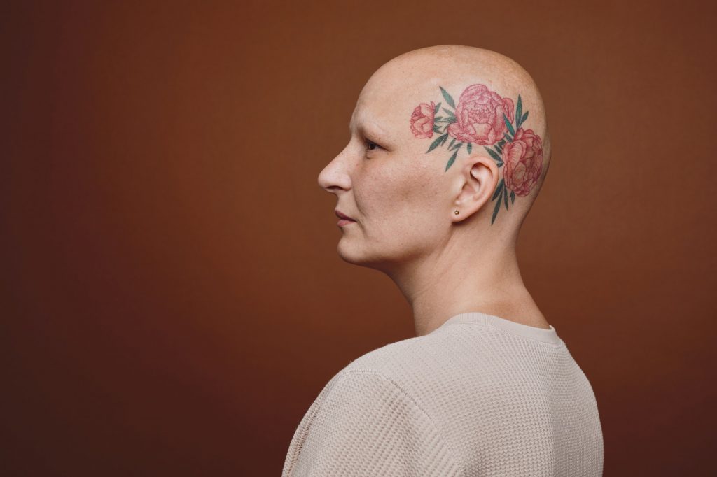 Side View of Bald Woman with Head Tattoo
